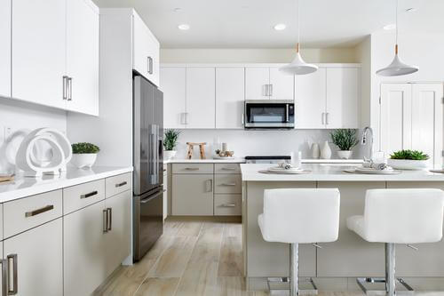white kitchen in Plan 2 at The QUE by Woodbridge Pacific Group