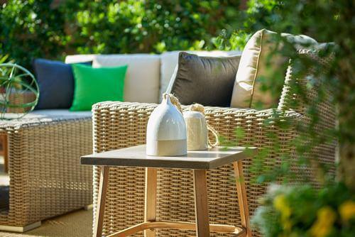 patio with wicker furniture and decorative pillows at The Covey