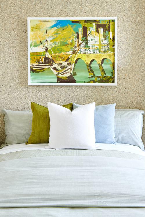 decorative bedroom pillows and painting at Residence Two at Skye
