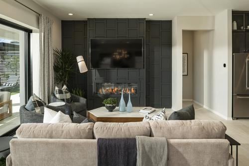 Living room with fireplace at Catalan Plan at Verrado by Toll Brothers Arizona