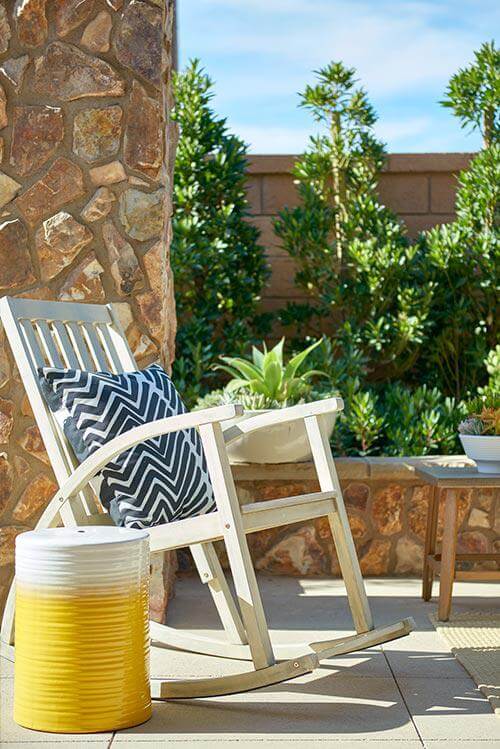 wood rocking chair and yellow stool on patio by Chameleon Design