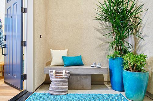 concrete bench and aqua accents on porch by Chameleon Design