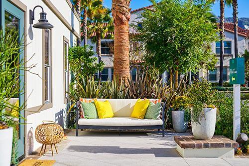 outdoor sofa with colorful cushions on porch by Chameleon Design