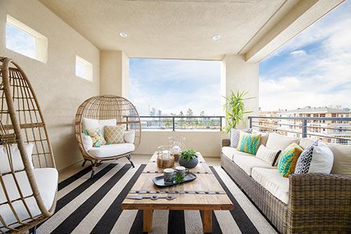 rattan and white lounge chairs on covered patio by Chameleon Design