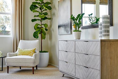 white accent chair in bedroom by Chameleon Design