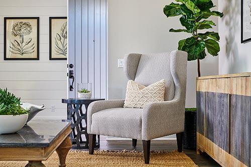 gray wingback accent chair in living room by Chameleon Design