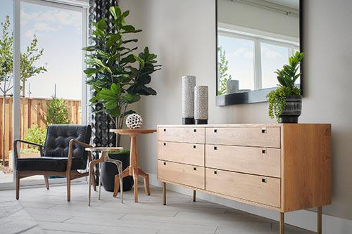 black leather and wood armchair in bedroom by Chameleon Design