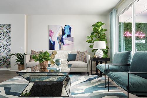 blue, gray, and white abstract rug in living room by Chameleon Design