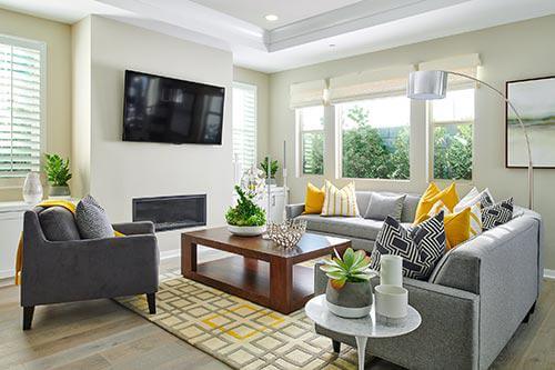 gray, yellow, and cream rug in living room by Chameleon Design