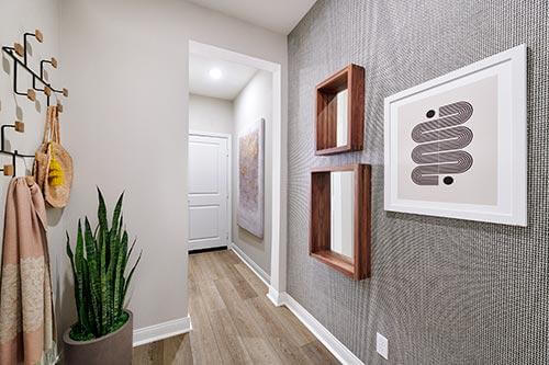 neutral entryway with wallpaper and line art