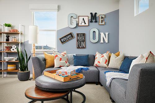 game room with blue and white painted accent wall Van Daele Homes Enliven
