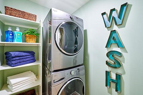 small laundry room with stackable washer and dryer Citrus + Palm