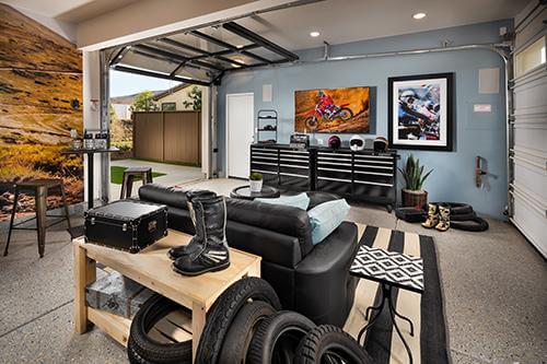 converted garage man cave with black sofa and accents Canvas