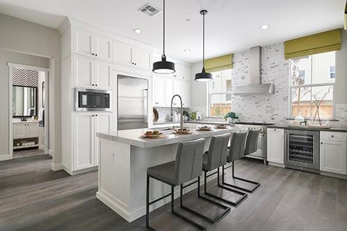 kitech with white cabinets and center island at Plan 1 Dover at Compass Bay in Newark, California