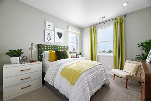 kids bedroom with white and wood furnishings and green accents at Plan 1 Dover at Compass Bay in Newark, California