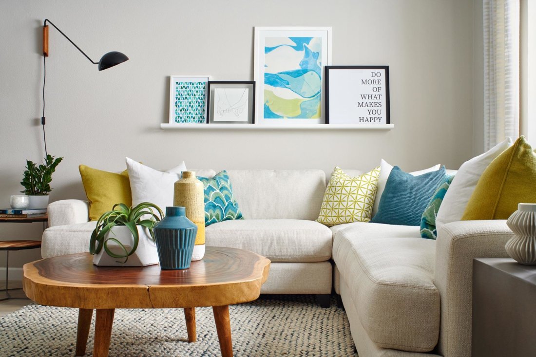 cream sofa with yellow and cerulean blue pillows in living room Indigo