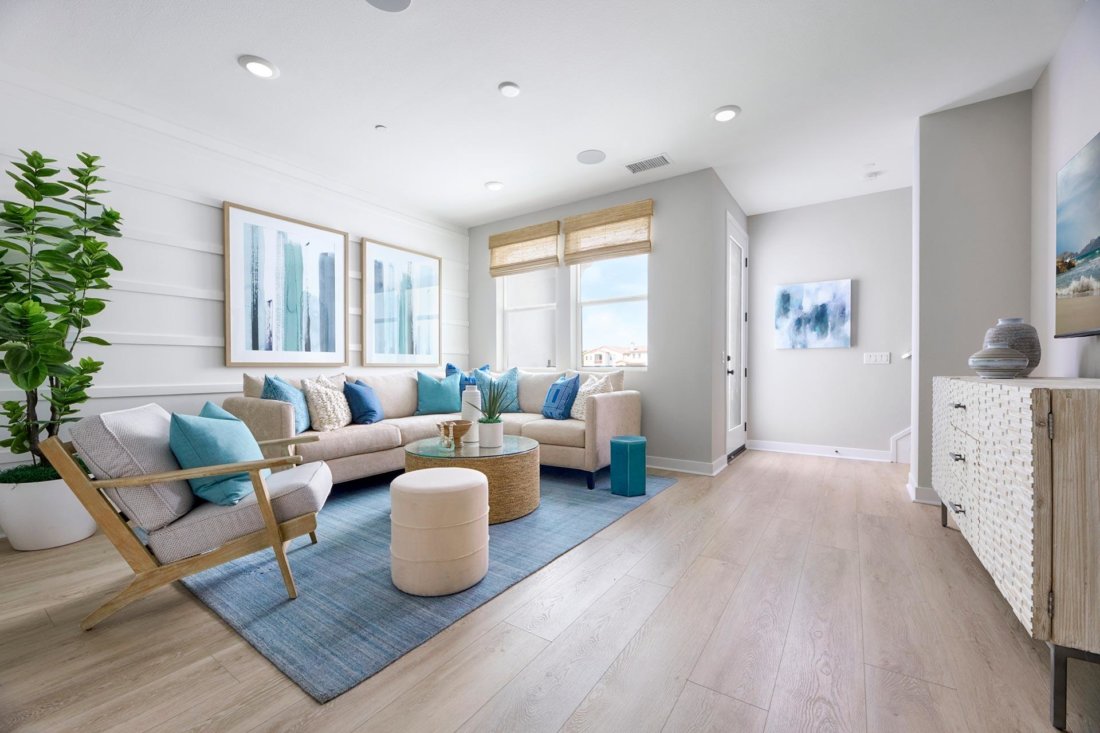 living room with blue rug and fiddle fig Townes at Magnolia Plan 2 Melia Homes