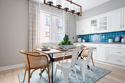 dine in kitchen with blue backsplash in kitchen Townes at Magnolia Plan 2 Melia Homes