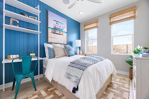 first floor bedroom with blue accent wall Townes at Magnolia Plan 2 Melia Homes
