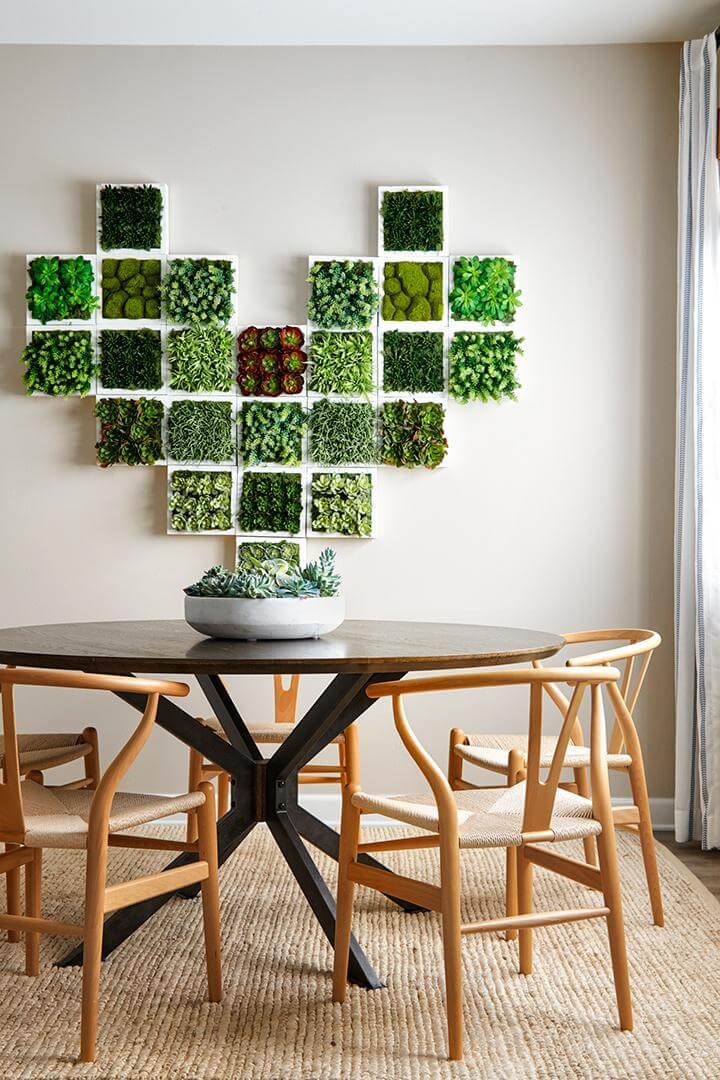 succulent heart shaped wall art, circular dining table with black base and wood top, potted succulents, rattan chairs, jute area rug in dining room, Gardens