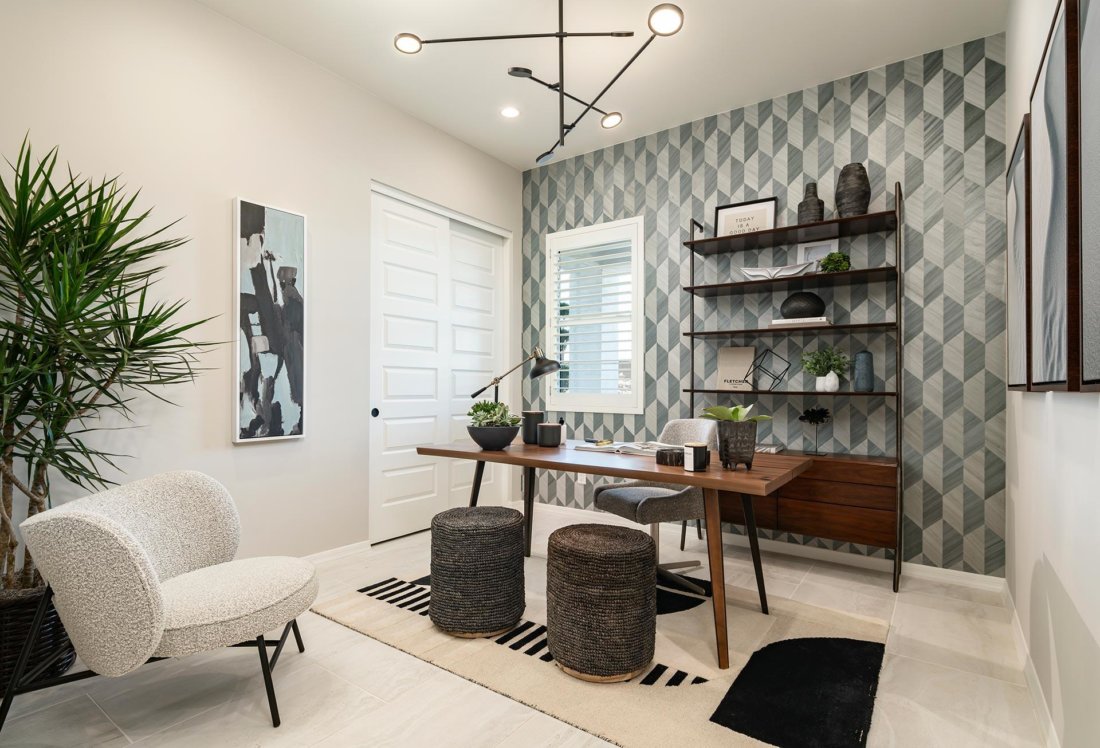 tonal gray hexagonal wallpaper, wood desk, matte black bookcase, cream and black area rug in home office Allevare