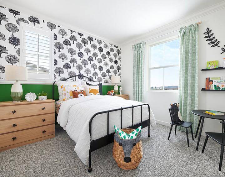 black tree patterned wallpaper, green painted wall, white bedding with woodland themed pillows, wood bedside tables, green patterned curtains, black kids table and chairs, woven basket in kids room, Splash at One Lake