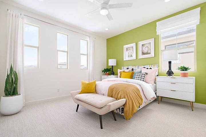 bedroom with bright green statement wall and modern furniture