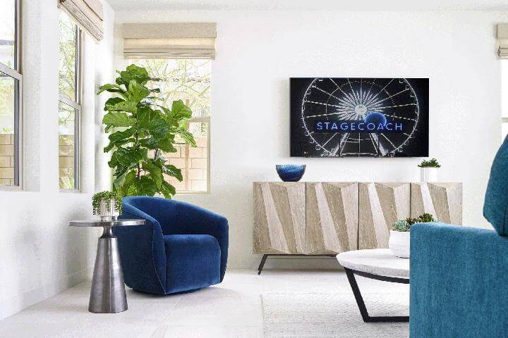 blue velvet chair, minimal living room with plants and modern furniture