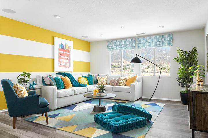 yellow striped wallpaper in a colorful living room with blue cushions