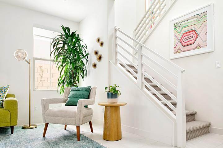 fresh white seating area with modern staircase and modern furniture
