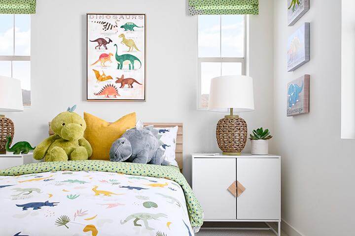 kids room with green accents and dinosaur bedding