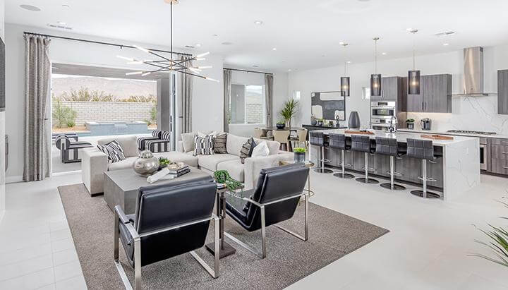 luxury open concept living room and kitchen area with leather chairs