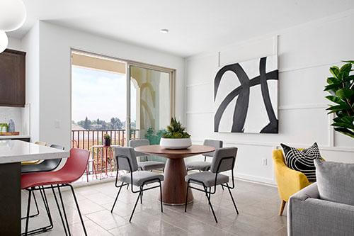 bright white dining area with abstract art and modern furniture