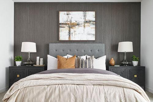 symmetrical neutral bedroom with wood look accent wall