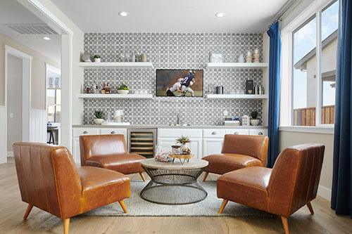 lounge area with white open shelving and club chairs