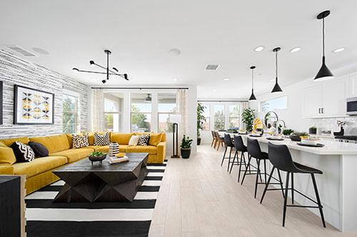 living room with yellow couch with black and white accents