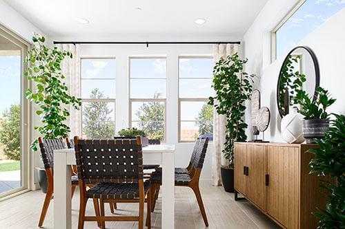 bright dining area with plants and large windows