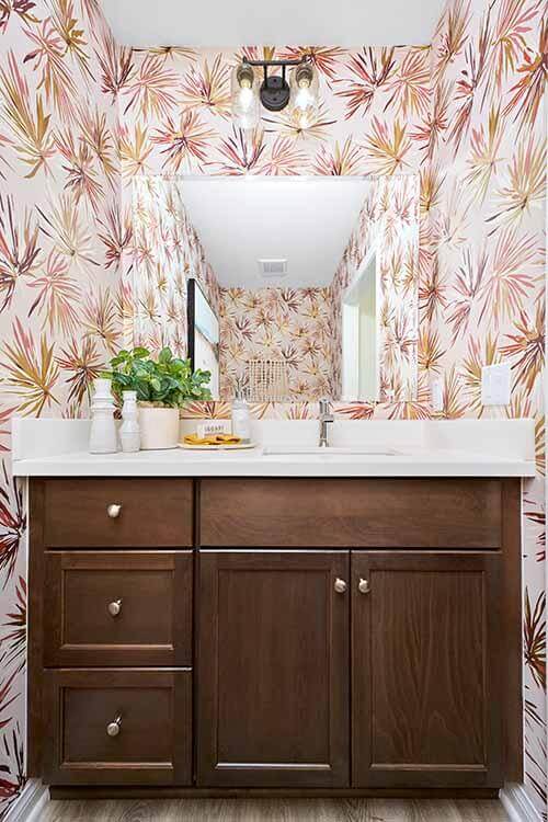 vibrant wallpaper and dark wood vanity in modern bathroom
