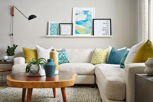 living room with single open shelf and colorful accent pillows