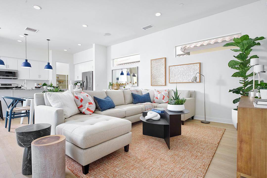 great room with white walls and neutral sectional