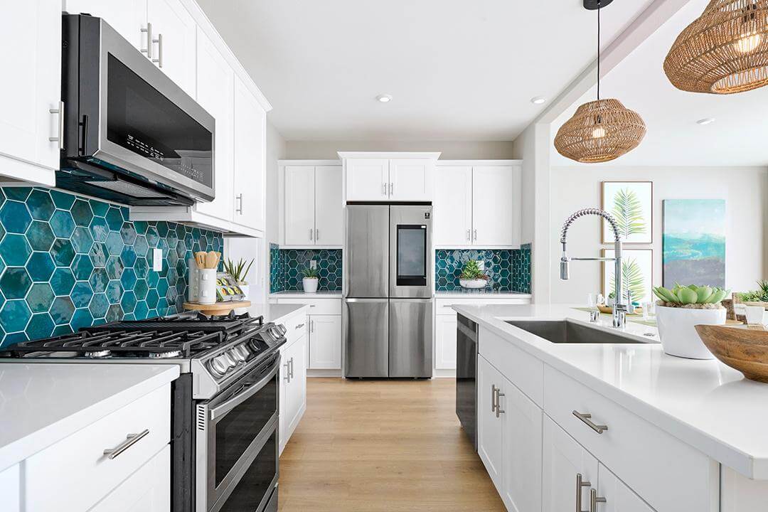 white kitchen with blue green hexagon tile backsplash