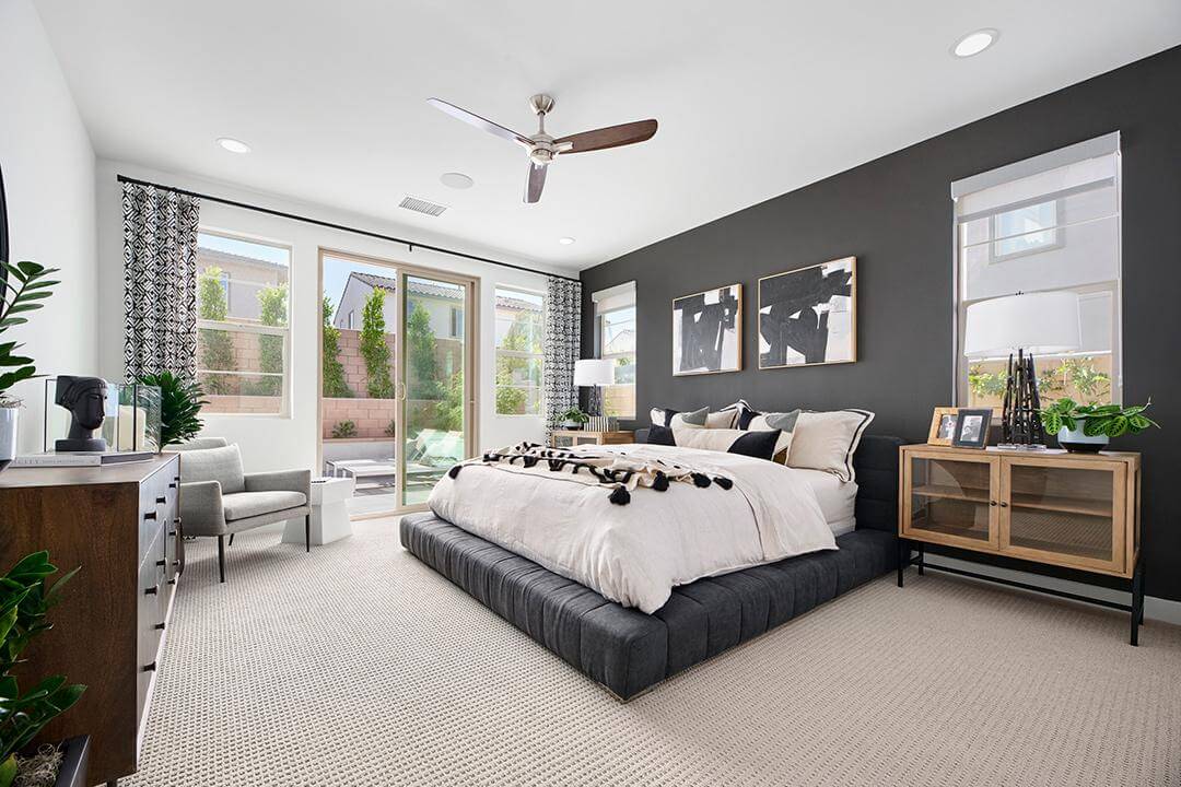 master suite with dark elements and charcoal wall