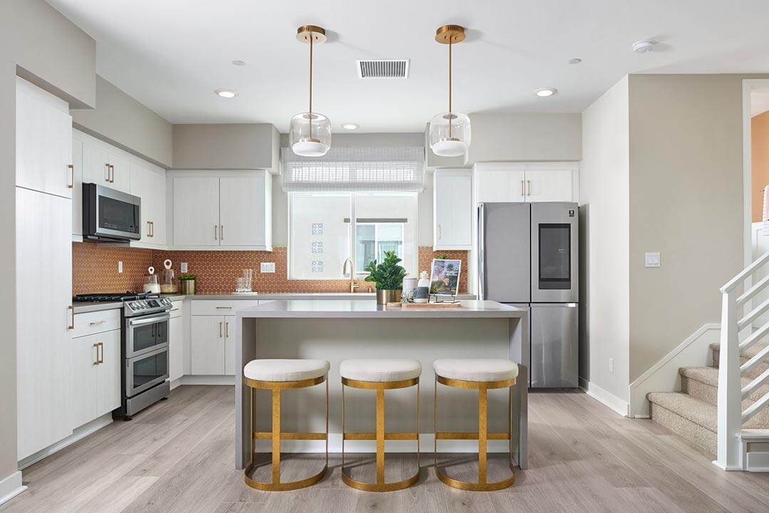 modern kitchen with barstools and pendant lights