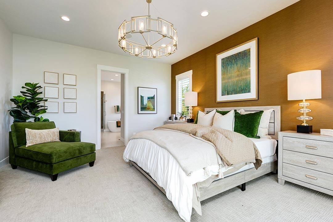 orange bedroom with chandelier and green chair