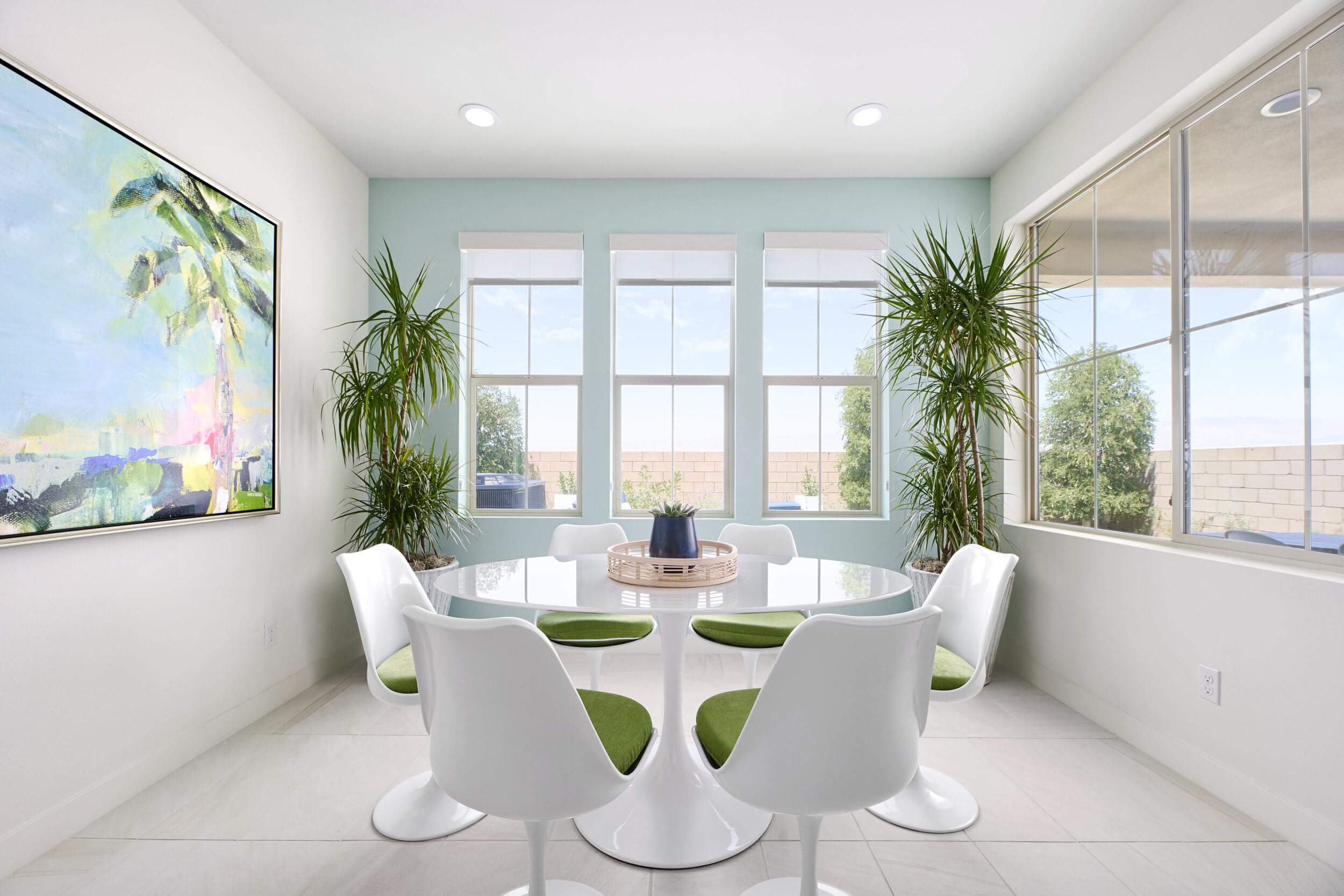 light blue dining room with retro table and chairs