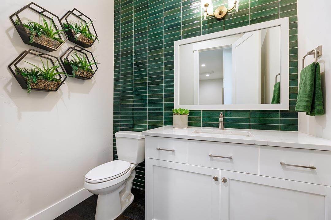 bathroom with green tile statement wall