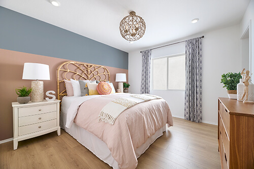 blue gray and peach paint bedroom with rattan headboard