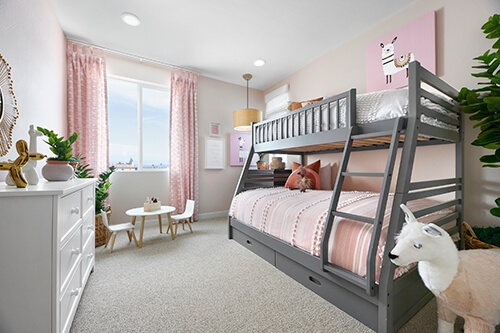 bright kids room with gray bunk beds and pink curtains