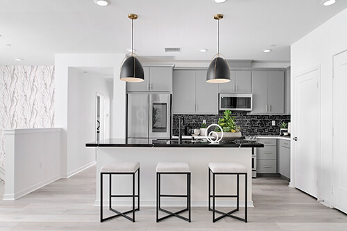 monochrome kitchen with black pendant lights