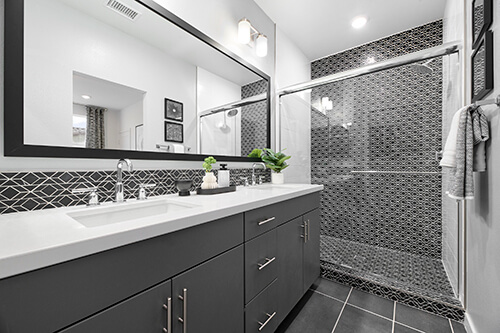 gray and white bathroom with small geometric tiles